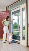 a woman and child in front of a white storm door