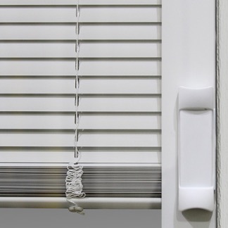 close up photo of white blinds inside glass