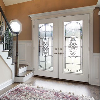 an interior photo of white double entry doors with handmade decorative glass